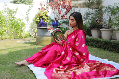 Gulab Banarasi pure silk saree in Rani pink, handwoven with floral butis in Kadhwa weave.

